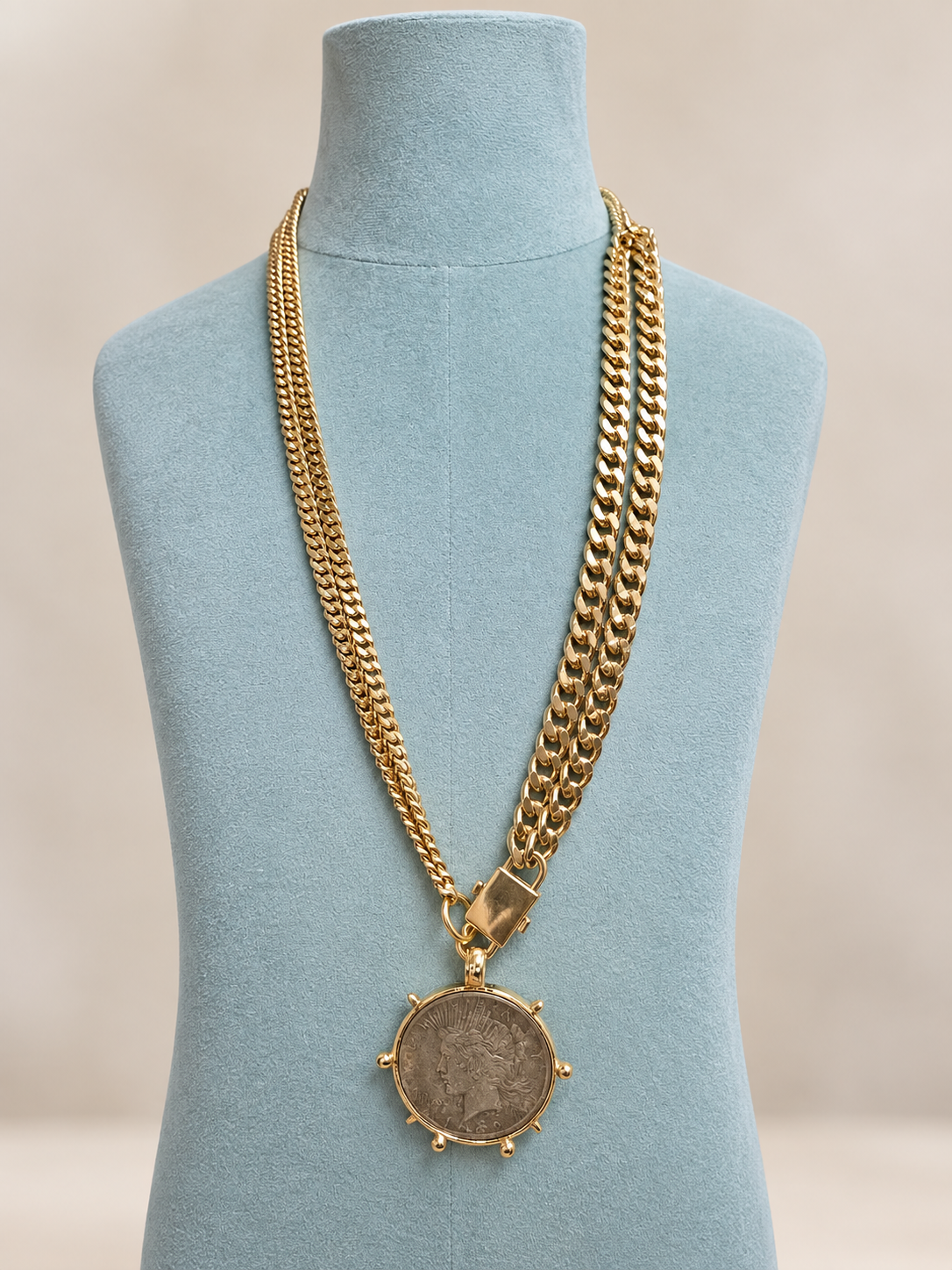 14K gold plated coin necklace on blue mannequin