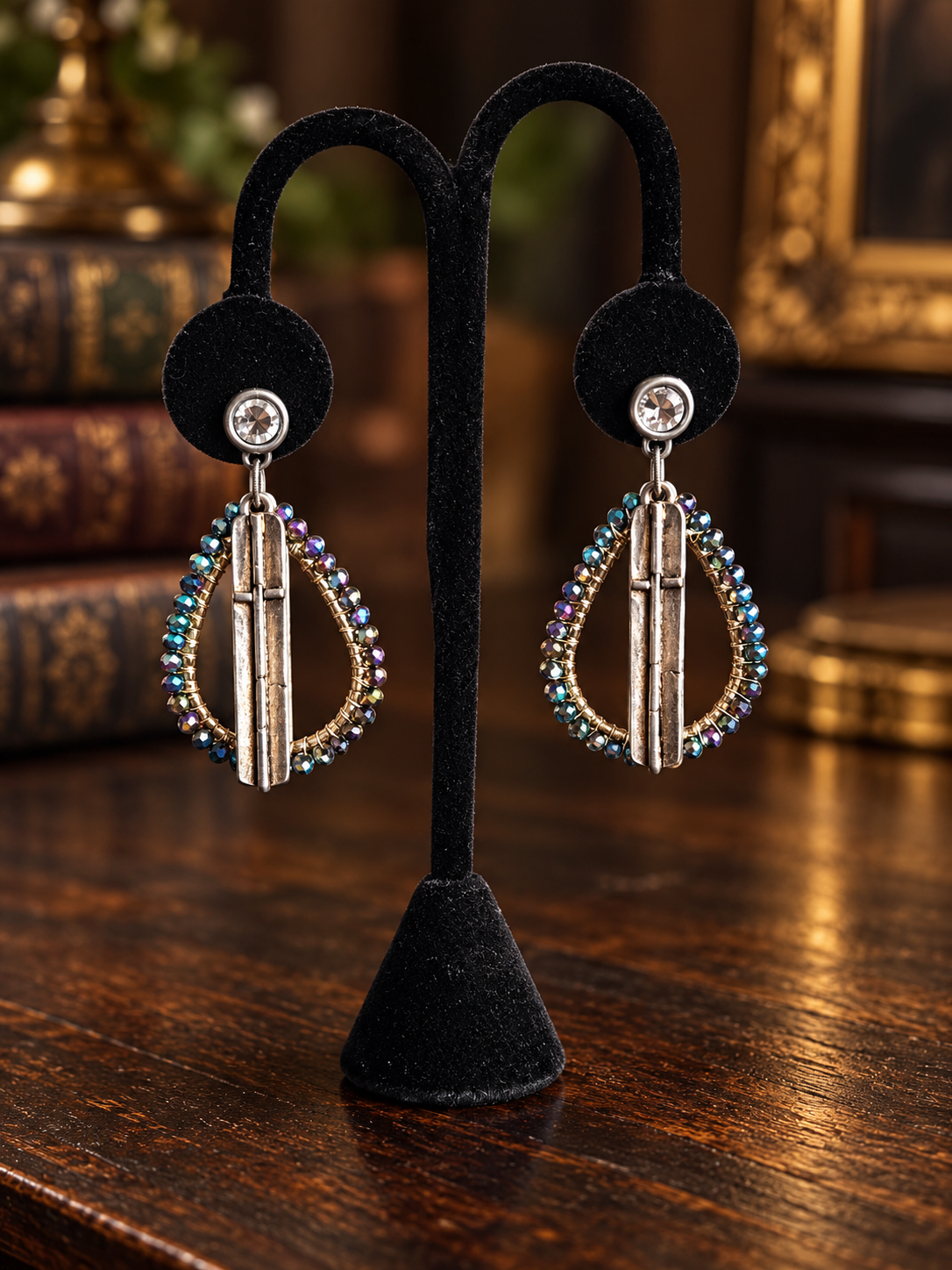 Iridescent beaded silver bar earrings on black velvet display