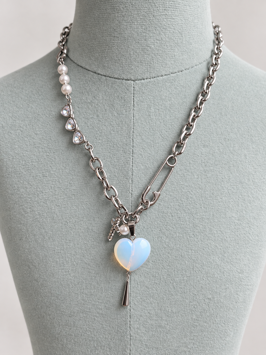 Stainless steel opalite heart necklace on neutral mannequin
