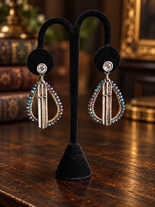 Iridescent beaded silver bar earrings on black velvet display