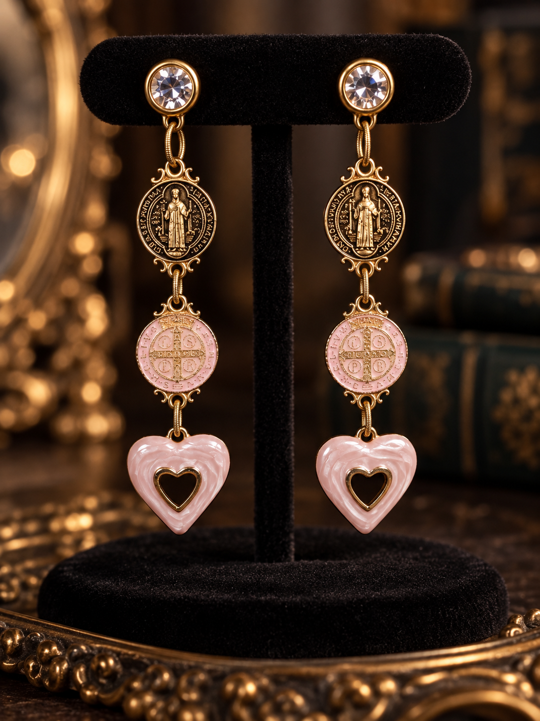 Pink heart saint medallion Swarovski earrings on black velvet display