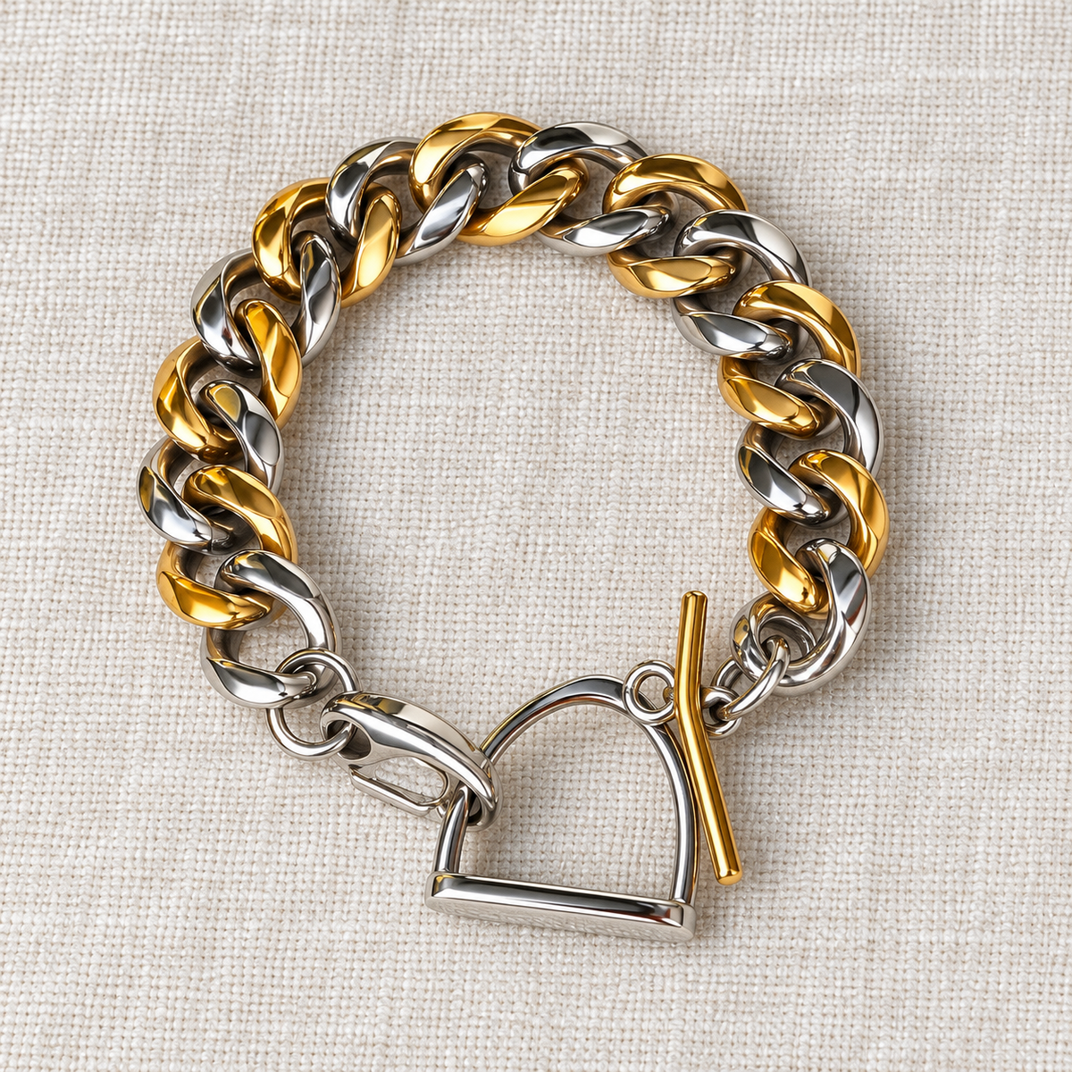 Two-tone stainless steel and 14K gold-plated toggle bracelet on linen